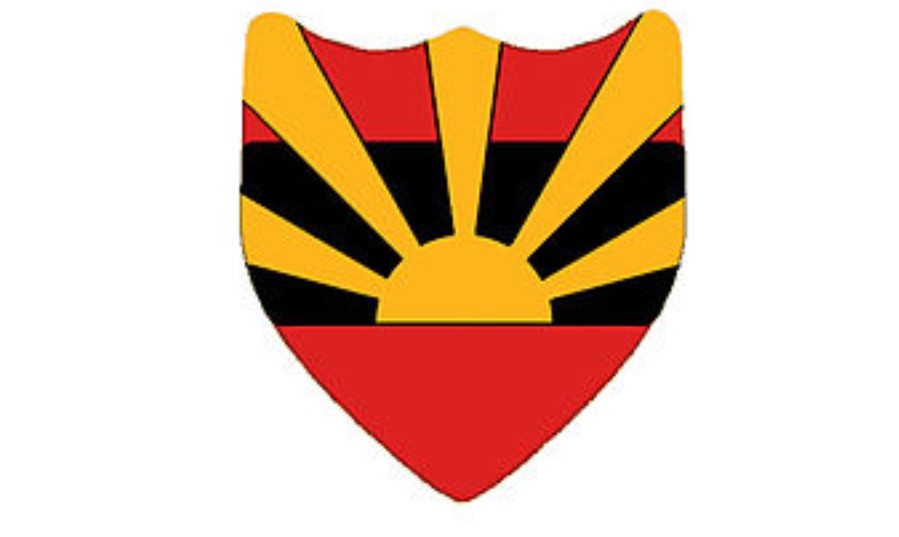shield emblem with rising sun design in red black and yellow colors